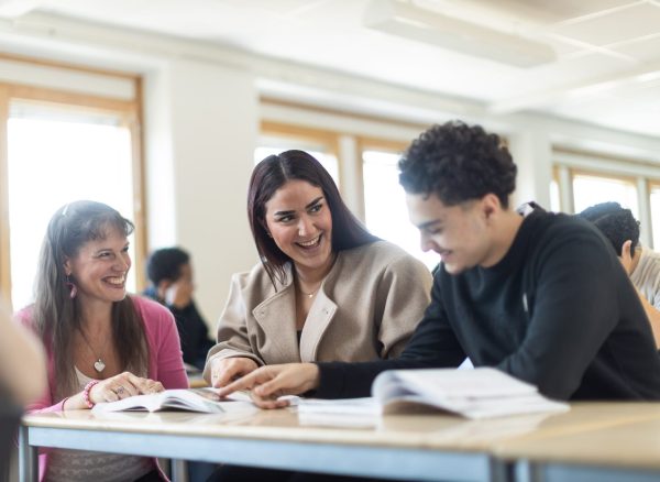 Elever skrattar tillsammans med lärare.